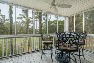3350 Club Villas Drive 104, Southport, NC 28461 — 2-bedroom condo in St James, Southport, NC, photo 15 of 34: Deck overlooking Golf & Woods