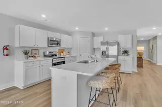 7111 Woodline Drive SW, Sunset Beach, NC 28468 – photo 21: Seaside Palms_Model_Venture_6911 Seaside