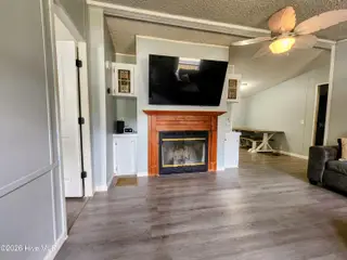 623 Sandy Bluff Drive SW, Supply, NC 28462 — 3-bedroom manufactured home in Sandy Bluff, Supply, NC, photo 4 of 26: Living Room Features TV & Fireplace