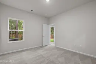 806 Palm Frond Way NW, Calabash, NC 28467 – photo 15: Primary bedroom view from bathroom door