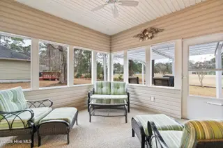 9 Golf Crest Court, Carolina Shores, NC 28467 — 3-bedroom home in Carolina Shores, Carolina Shores, NC, photo 10 of 46: Screened Porch