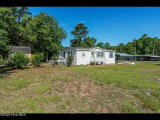 6883 Eastbrook Avenue SW, Ocean Isle Beach, NC 28469 — 2-bedroom manufactured home in Pine Acres, Ocean Isle Beach, NC, photo 6 of 25: Property from Road