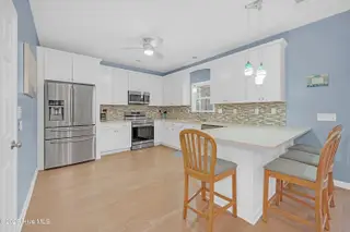 409 Womble Street, Oak Island, NC 28465 – photo 16: Kitchen with 4 counter seating