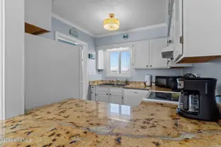 1000 Caswell Beach Road Apt. 806, Oak Island, NC 28465 — 2-bedroom condo in Oak Island Bch Villa, Oak Island, NC, photo 15 of 56: View from Dining Area to Kitchen