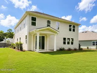 8611 Blue Haw Way Lot 124, Leland, NC 28451 — 5-bedroom home in Indigo Preserve, Leland, NC, photo 3 of 33: Covered Porch and back yard space