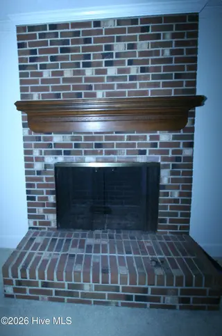 1313 Rondo Drive, Greenville, NC 27858 – photo 6: Downstairs Fireplace with Wooden Mantel