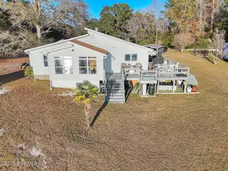 1229 Fletcher Hewett Road SW, Shallotte, NC 28470 — 2-bedroom home, Shallotte, NC, photo 1 of 52: Front/Side