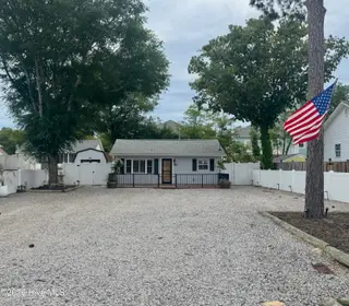 113 NW 12th Street, Oak Island, NC 28465 – photo 2: Spacious Gravel Lot