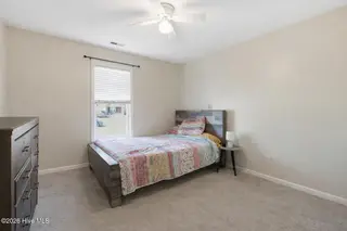 404 Hidden Oaks Drive, Jacksonville, NC 28546 – photo 24: Cozy bedroom with rustic charm