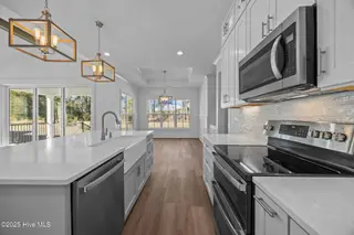 498 Genoes Point Road SW, Supply, NC 28462 – photo 13: Kitchen with Center island and farm sink