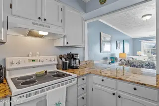 1000 Caswell Beach Road Apt. 806, Oak Island, NC 28465 — 2-bedroom condo in Oak Island Bch Villa, Oak Island, NC, photo 13 of 56: Counter Pass through to Living Area