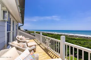 125 Roosevelt Drive, Pine Knoll Shores, NC 28512 — 5-bedroom home in Roosevelt Beach, Pine Knoll Shores, NC, photo 9 of 61: Private balcony off primary suite