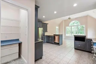86 Plantation Passage Drive SE, Bolivia, NC 28422 — 4-bedroom home in Winding River Plantation, Bolivia, NC, photo 16 of 77: Pantry and Kitchen