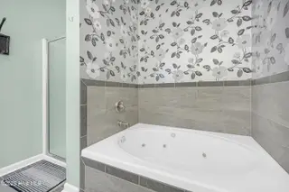 409 Womble Street, Oak Island, NC 28465 – photo 23: Jetted Sunken Tub in Primary Bathroom