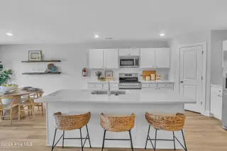7111 Woodline Drive SW, Sunset Beach, NC 28468 – photo 20: Seaside Palms_Model_Venture_6911 Seaside