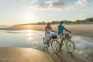 3217 Butterfly Ginger Street Lot 75, Leland, NC 28451 — 3-bedroom home in Indigo Preserve, Leland, NC, photo 19 of 49: Biking on the Beach