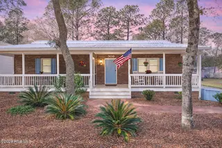 309 NE 41st Street, Oak Island, NC 28465 – photo 13: Twilight at a charming home