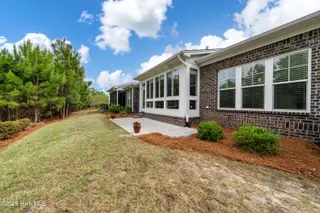 8983 Mango Bay Court NE, Leland, NC 28451 — 4-bedroom townhome in Compass Pointe, Leland, NC, photo 22 of 53: Rear Exterior with Back Patio