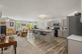 737 Landmark Cove, Carolina Shores, NC 28467 — 4-bedroom home in Landmark at Lighthouse Cove, Carolina Shores, NC, photo 6 of 39: Kitchen and Living Area