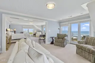 125 Roosevelt Drive, Pine Knoll Shores, NC 28512 — 5-bedroom home in Roosevelt Beach, Pine Knoll Shores, NC, photo 7 of 61: Top floor primary suite w/ sitting area