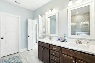 6479 Bryson Drive SW, Ocean Isle Beach, NC 28469 – photo 22: Vanity/pocket door to toilet closet