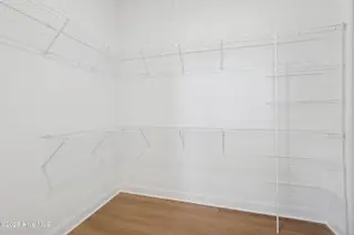 1560 St. Lucia Drive SW, Shallotte, NC 28470 – photo 10: Walk-in Closet in Primary Suite