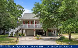 109 NE 1st Street, Oak Island, NC 28465 – photo 1: 109 NE 1st Street with owrding