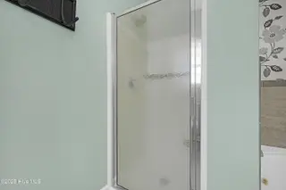 409 Womble Street, Oak Island, NC 28465 – photo 24: Walk-in Shower in Primary Bathroom