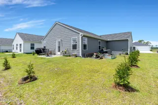 4901 Abbington Oaks Way SE, Southport, NC 28461 — 3-bedroom home in Groves at Southport, Southport, NC, photo 24 of 31: Rear Exterior