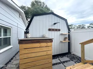113 NW 12th Street, Oak Island, NC 28465 – photo 19: Wood Casing Enclosed Propane Tank