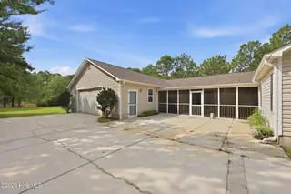 133 Sheldon Street, Newport, NC 28570 – photo 2: courtyard/screened porch side of house