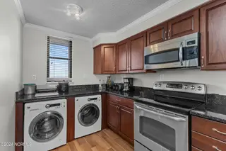 1505 Salter Path Road 304, Indian Beach, NC 28512 — 2-bedroom condo in Summer Winds Condominiums, Indian Beach, NC, photo 12 of 53: Kitchen & Laundry