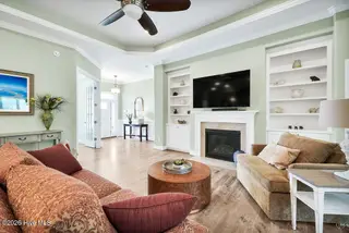 5117 Stoney Point Drive, Leland, NC 28451 – photo 10: Living room with fireplace and built ins