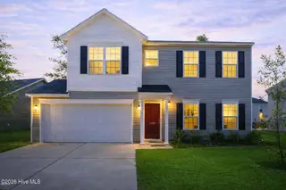 1439 Judith Drive SE, Bolivia, NC 28422 – photo 3: Charming home at twilight