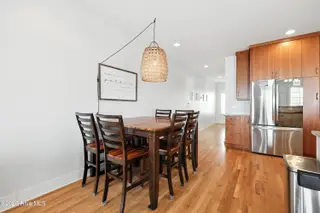 1106 Fort Fisher Boulevard N Unit 1, Kure Beach, NC 28449 – photo 19: 17 - Dining, Kitchen, Hall to Stairwell
