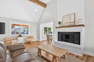 501 Shoreline Drive E, Sunset Beach, NC 28468 – photo 10: Word-burning fireplace with shiplap