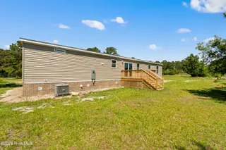 490 Orchard Lane SE, Bolivia, NC 28422 — 3-bedroom manufactured home in Vineyard Plantation, Bolivia, NC, photo 4 of 27: Back yard