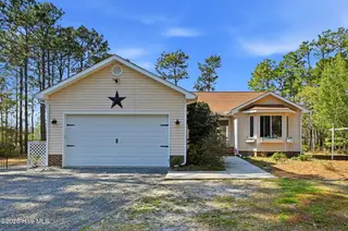 1281 Spring Lake Drive, Southport, NC 28461 — 3-bedroom home, Southport, NC, photo 2 of 46: Front Exterior with Mature Landscaping