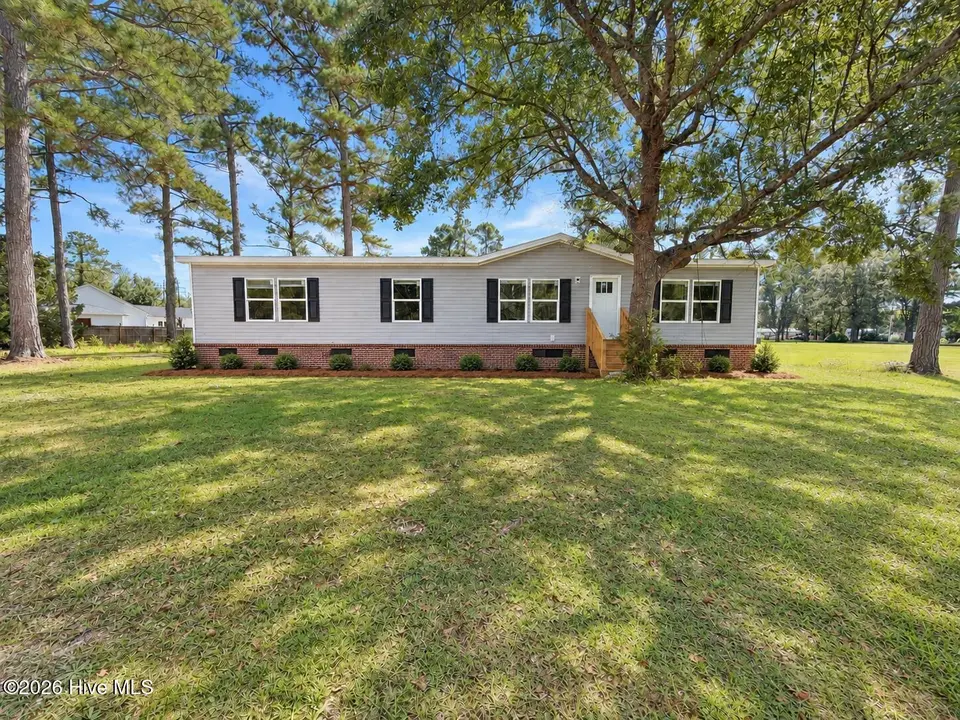 809 Garner Drive, Newport, NC 28570 – photo 1 of 12: Ai enhanced front of 809 Garner