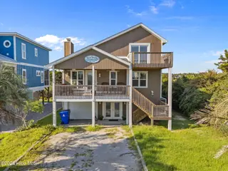 312 E Dolphin Drive, Oak Island, NC 28465 – photo 1: 1-web-or-mls-DJI_20250826170800_0118_D