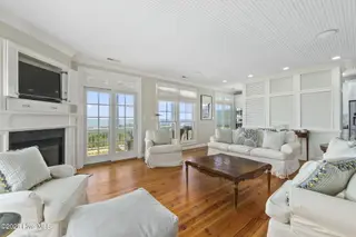 125 Roosevelt Drive, Pine Knoll Shores, NC 28512 — 5-bedroom home in Roosevelt Beach, Pine Knoll Shores, NC, photo 15 of 61: Light-filled LR w/ fireplace
