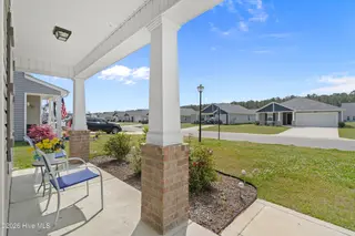 737 Landmark Cove, Carolina Shores, NC 28467 — 4-bedroom home in Landmark at Lighthouse Cove, Carolina Shores, NC, photo 3 of 39: Covered Front Porch