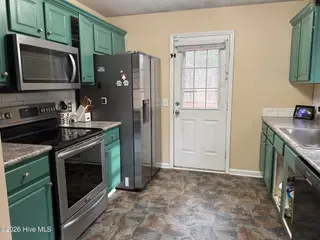 159 Edinburgh Drive, Carthage, NC 28327 — 3-bedroom home in Dundee Estates, Carthage, NC, photo 5 of 14: Kitchen - Patio Access