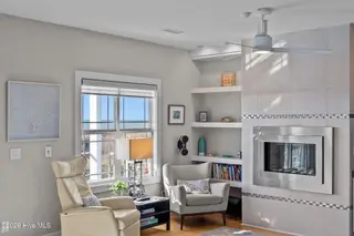 7403 E Beach Drive, Oak Island, NC 28465 – photo 17: Ocean View Living with Cozy Fireplace