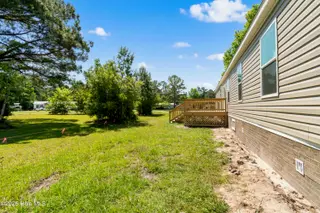 490 Orchard Lane SE, Bolivia, NC 28422 — 3-bedroom manufactured home in Vineyard Plantation, Bolivia, NC, photo 3 of 27: Back porch