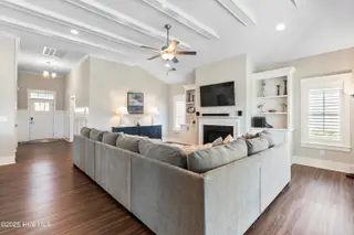 6475 Bryson Drive SW, Ocean Isle Beach, NC 28469 – photo 9: Ceiling beams, fireplace, bookcases