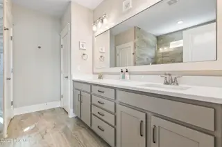 6475 Bryson Drive SW, Ocean Isle Beach, NC 28469 – photo 22: Dual quartz sinks/toilet & linen closets