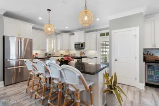 221 Sound Side Drive, Atlantic Beach, NC 28512 — 5-bedroom home in Bay Ridge, Atlantic Beach, NC, photo 4 of 60: Kitchen with island seating