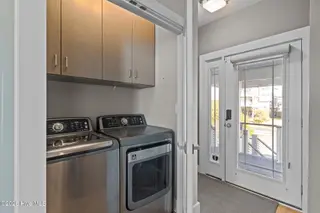 7403 E Beach Drive, Oak Island, NC 28465 – photo 22: Convenient Laundry Closet