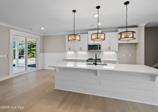 161 Twining Rose Lane, Holly Ridge, NC 28445 – photo 5: kitchen opens to screened-in porch